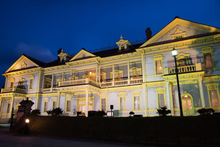 Old Public Hall of Hakodate lit up at night, showcasing historical architectural beauty