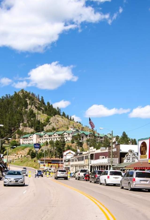 Downtown Keystone at dusk, showcasing historic buildings and the surrounding Black Hills