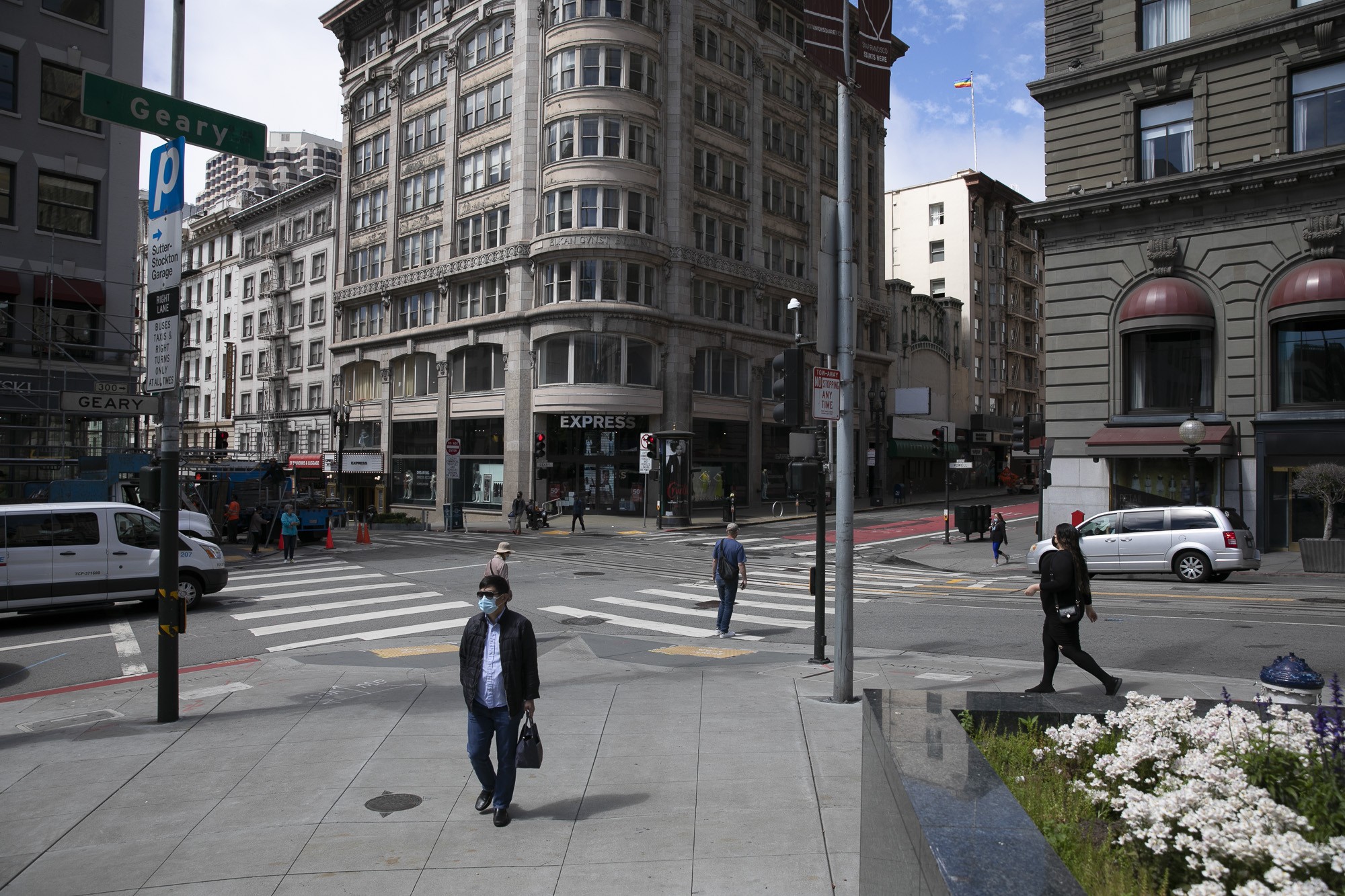 Tourists stroll through San Francisco's Union Square, illustrating the city's efforts to revitalize its tourism sector after pandemic-related restrictions