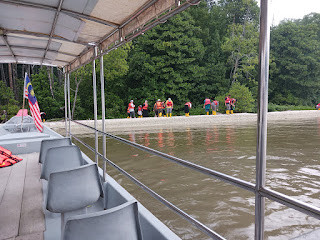 Khairul Salleh explaining the cage fish industry in Kuala Sepetang to tourists