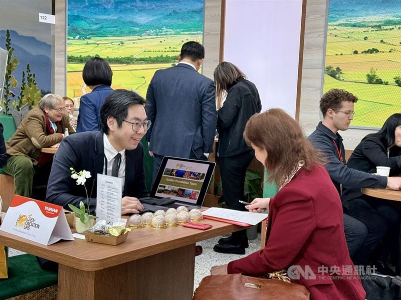 Tourism operators at Taiwan’s ITB Berlin booth engage with potential partners, promoting Taiwan's attractions.