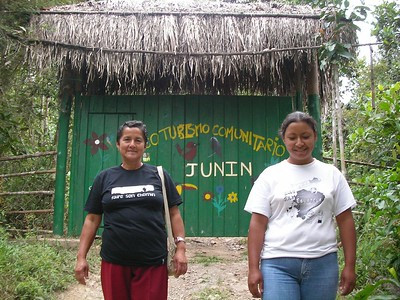 A group of tourists interacting with local community members, showcasing the importance of community conservation in environmental tourism.