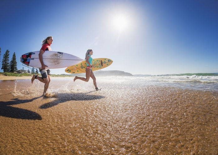 Two surfers heading out to enjoy the morning waves at Sydney