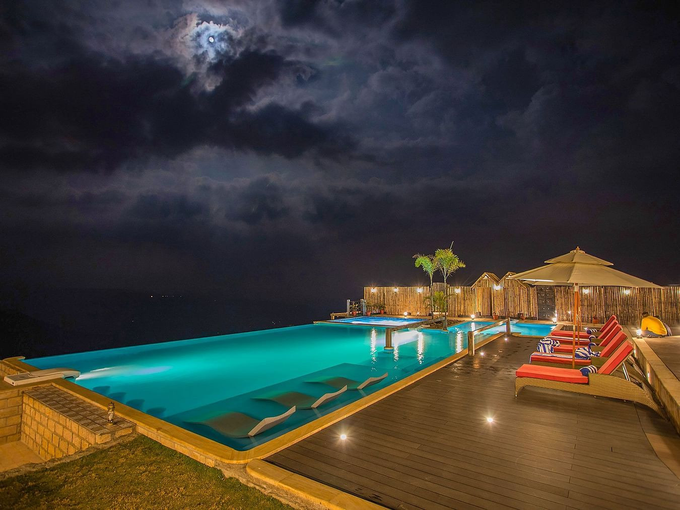 Infinity Pool at Polo Orchid Resort Cherrapunjee lit up at night.