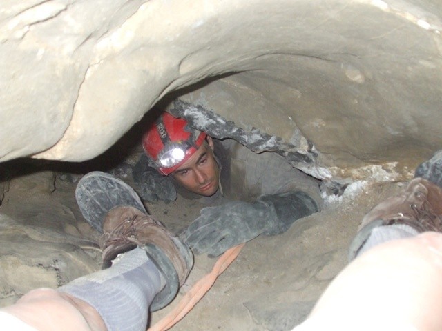 This is me and the legs of the paramedic in the passage leading down to where John is trapped. We are at the between the D5 and D6 survey stations on the illustration above. You can see where we were attempting to jack-hammer the passage. Notice how the passage is just about as tall as the paramedic’s boots.