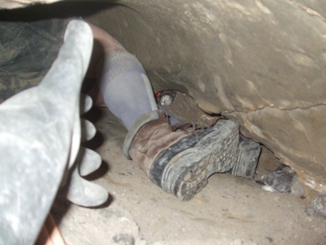 Looking at the paramedic’s feet from my perspective, between D7 and D9 just above John. In this shot and the previous shot my feet would have been just above John. Again showing how I can touch both ceiling and floor with my hand to show the tightness of the passage.