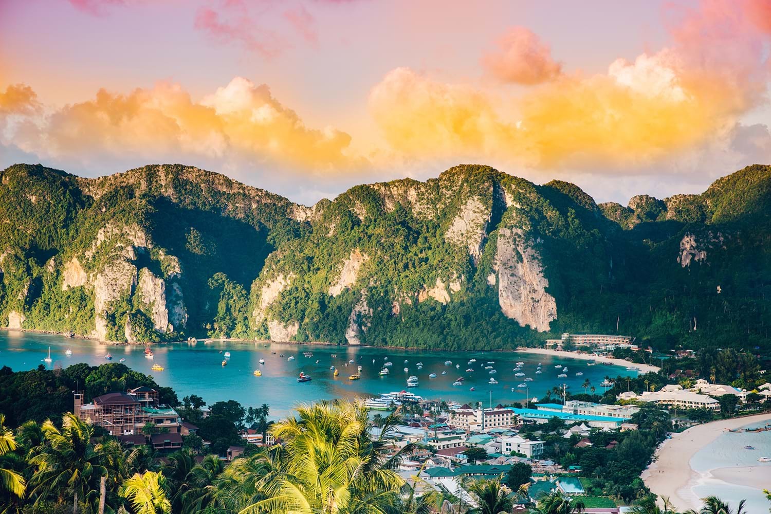view of bay surrounded by mountains during golden hour