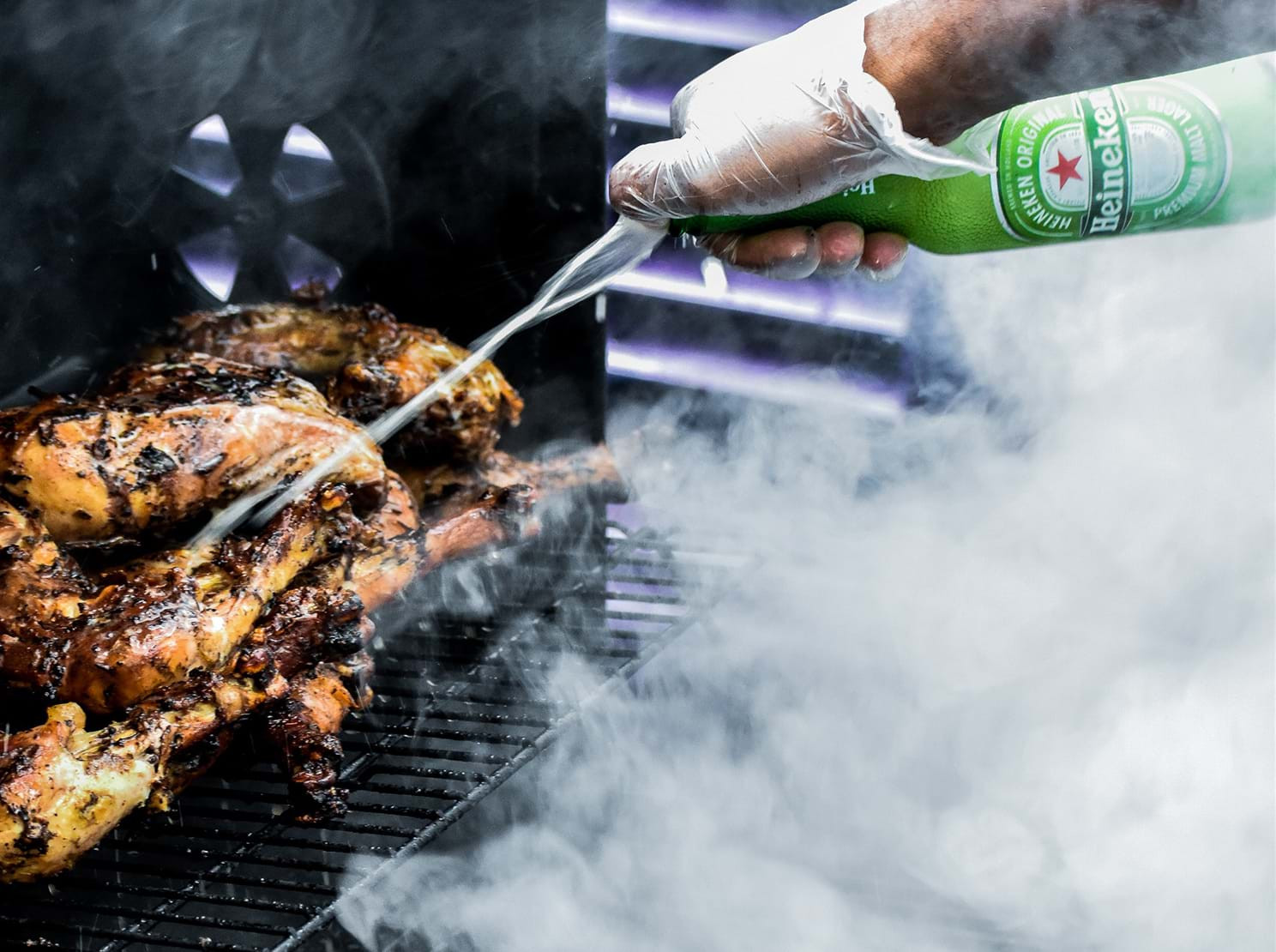 Jerk chicken being cooked on a grill