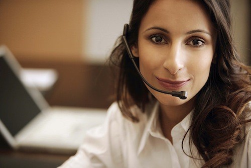 Customer service agent wearing headset answering call, illustrating personalized travel consultation
