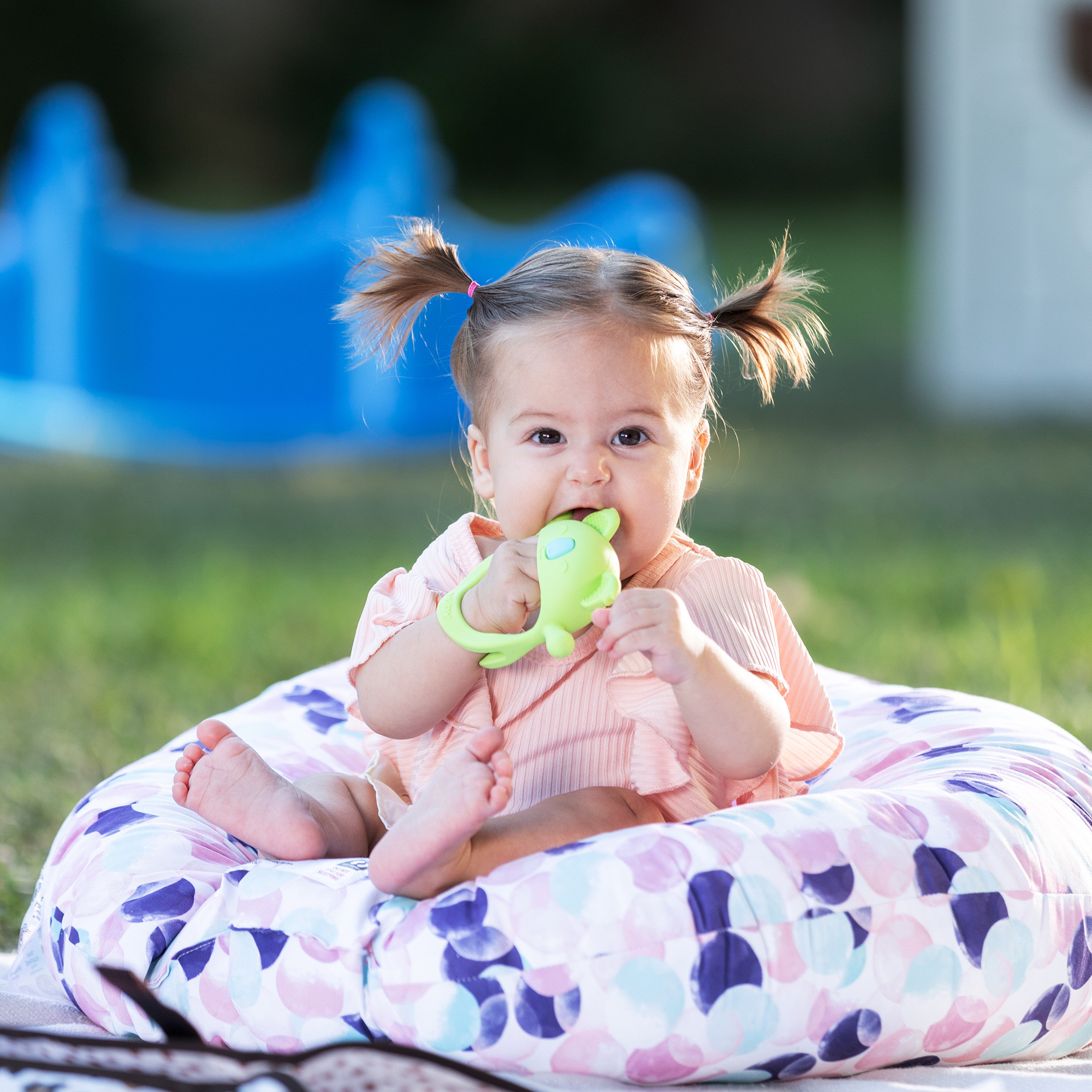 Baby using a teething mitten while traveling