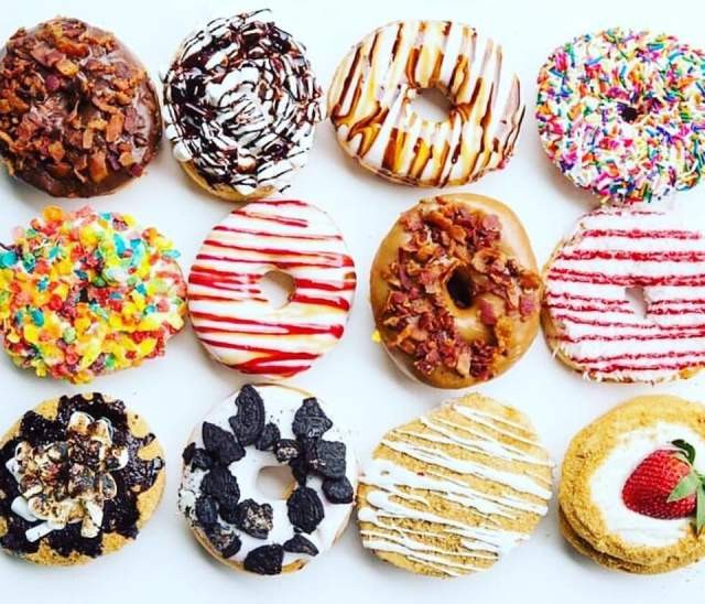 Several donuts with different toppings, Alt Text Houston Donuts