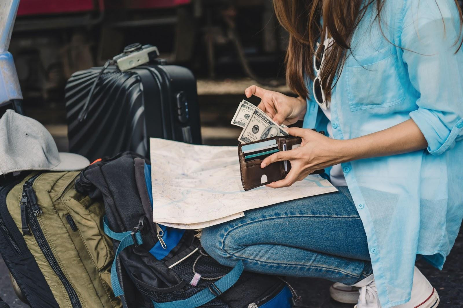Traveler checks cash in wallet before a trip