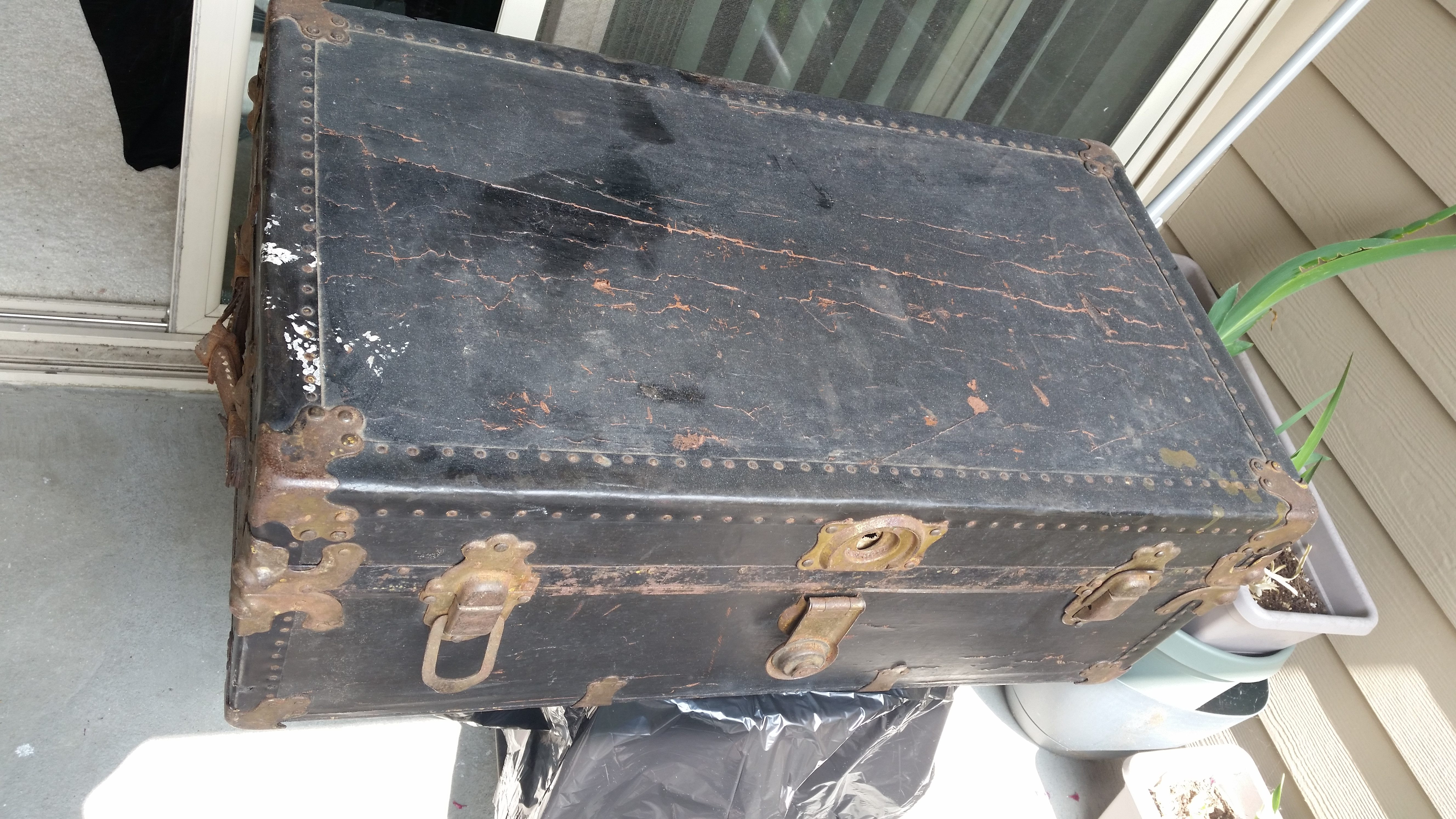 Close-up of an antique trunk's hardware, emphasizing the craftsmanship