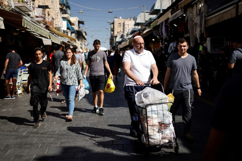 Shoppers at the Mahane Yehuda Market in Jerusalem, highlighting local commerce and community life