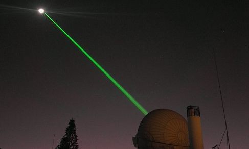 Red laser pointer on a black surface