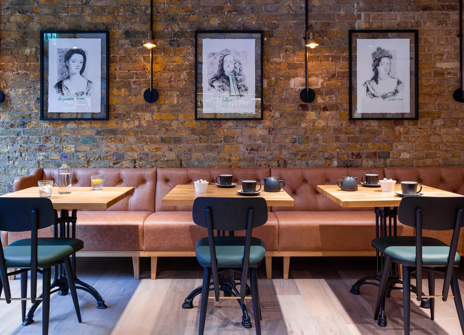 A chic restaurant with orange booths and teal chairs, representing upscale dining and travel experiences