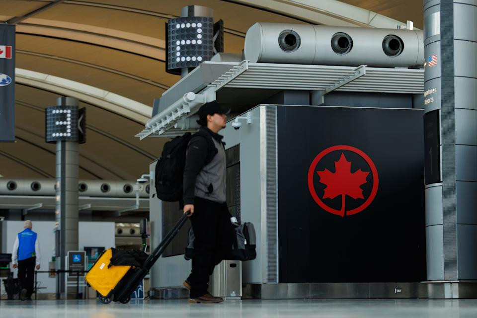 Travelers at an airport, possibly experiencing delays or cancellations