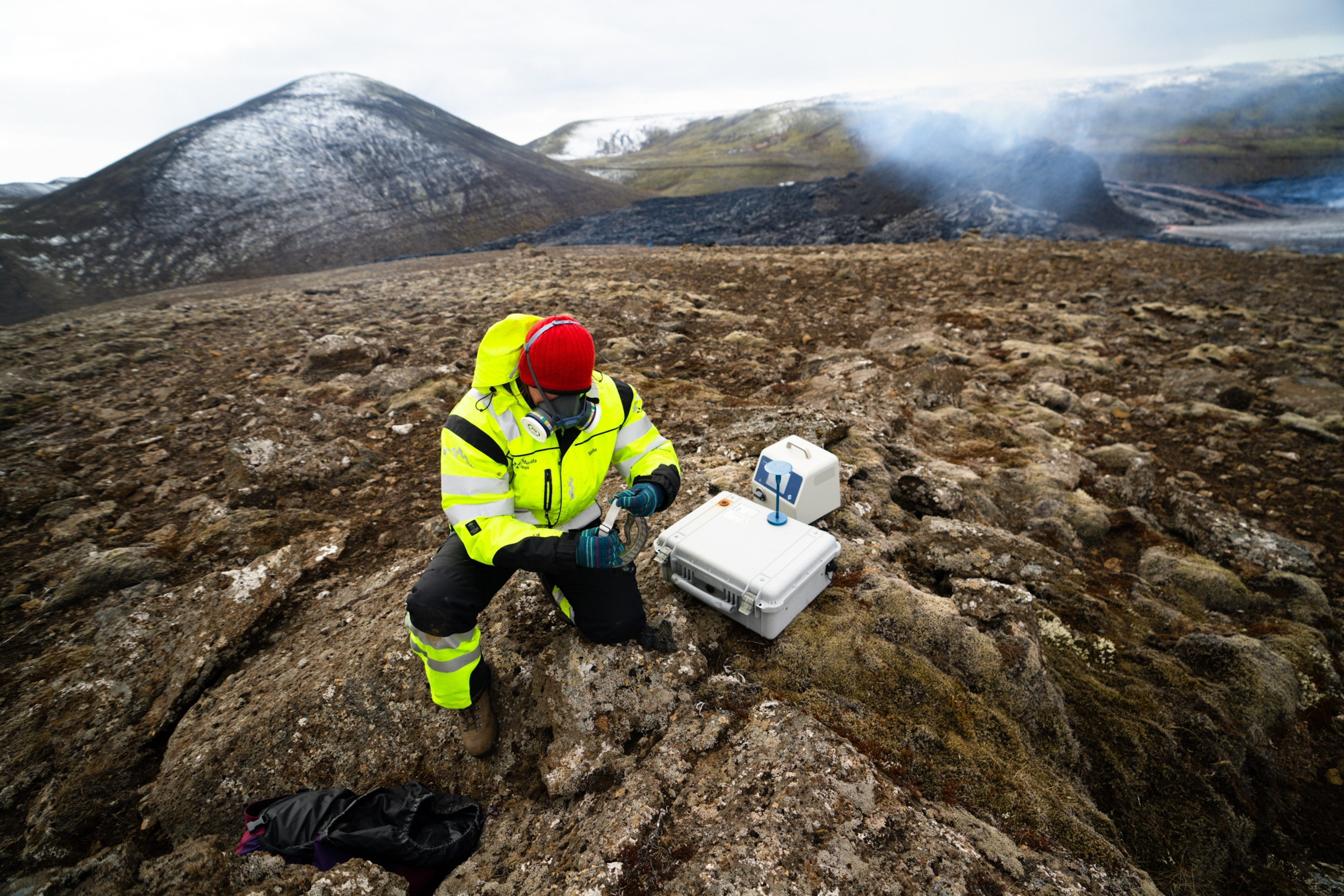 Members of the Search and Rescue Team monitoring gas levels near a volcanic eruption