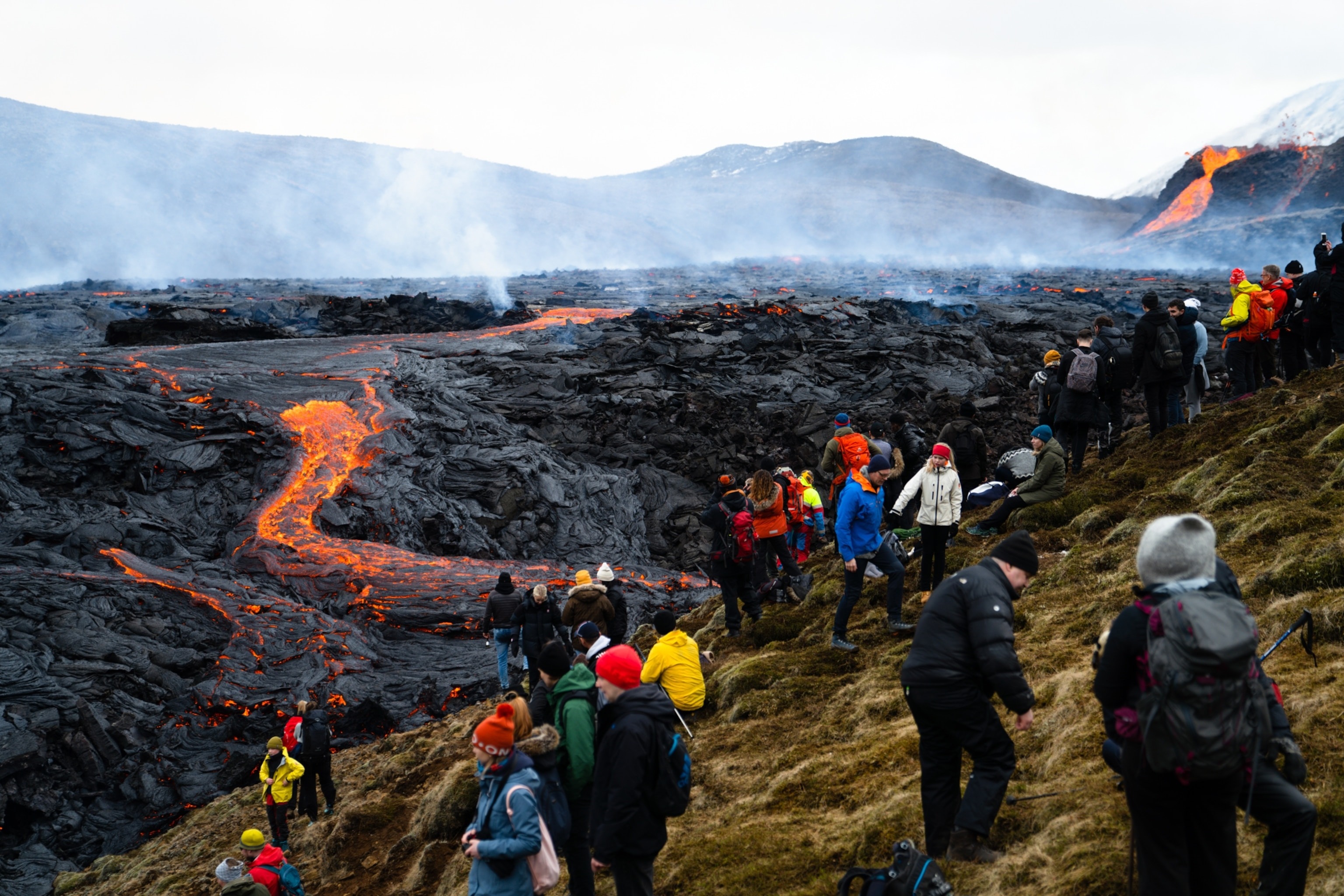 Tourists taking photos near a volcano
