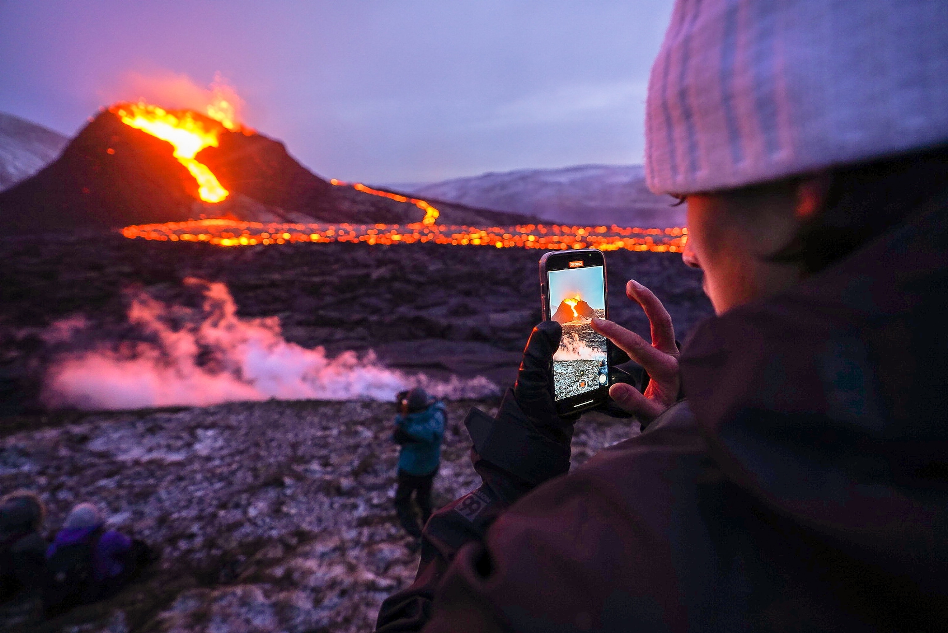 Volcanic landscape with tourists walking around