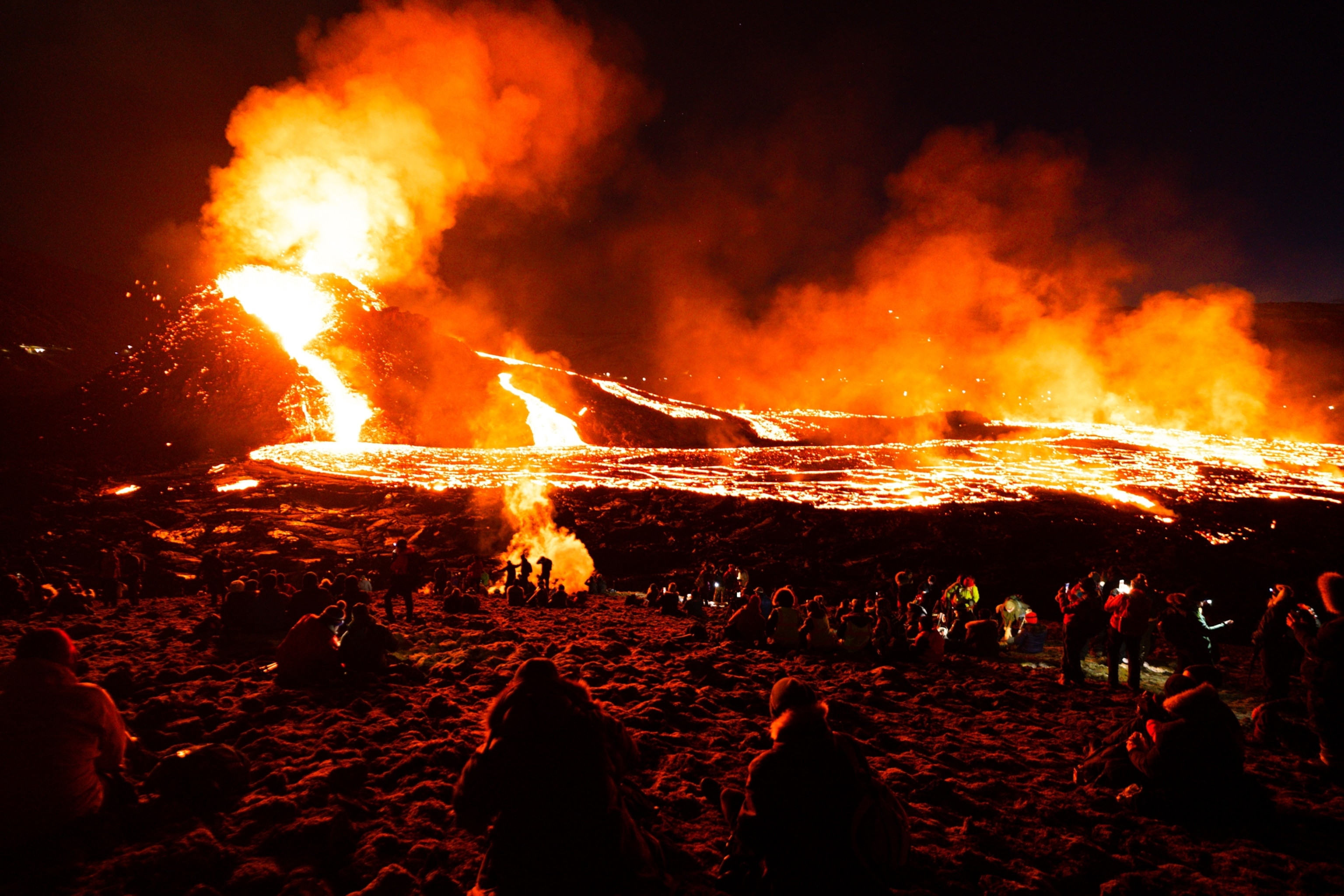 Tourists taking photos of a volcano