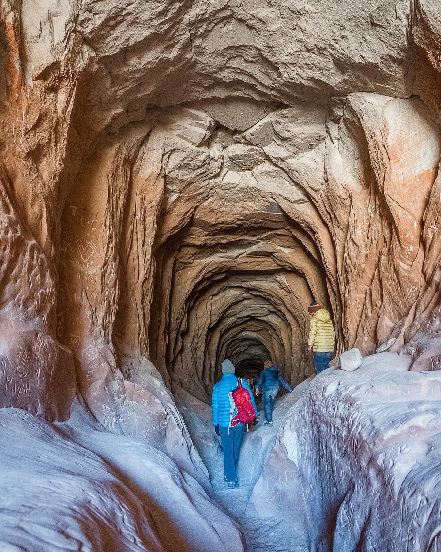 Family exploring the Belly of the Dragon, a man-made cave-like tunnel near Kanab, Utah, during a Spring Break road trip in 2021