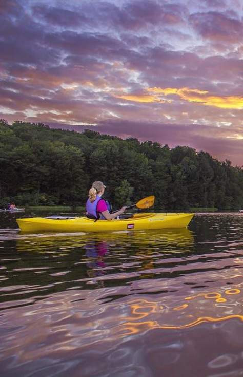 A kayaker navigates a picturesque lake at Lackawanna State Park