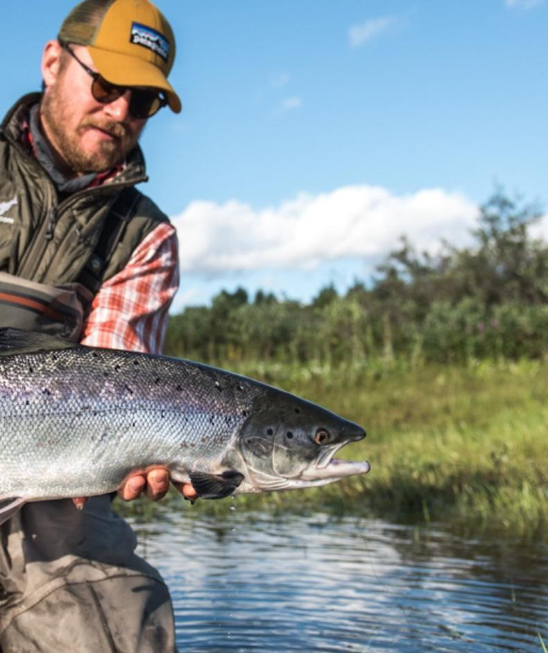 Angler holding a small travel fishing rod Maxwell