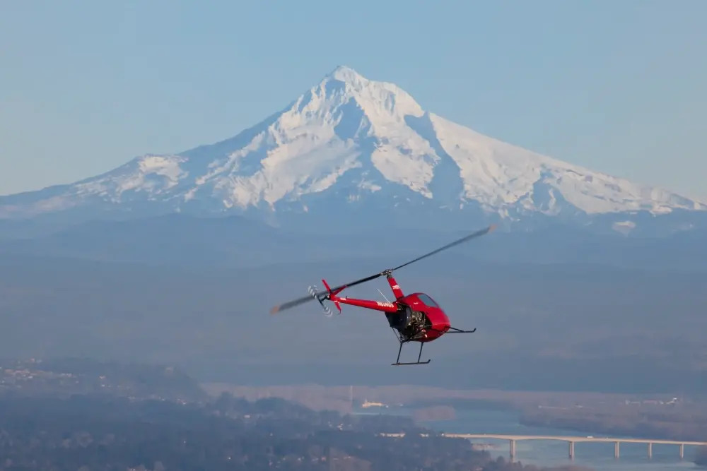 bell-407-helicopter-flying-over-mountain