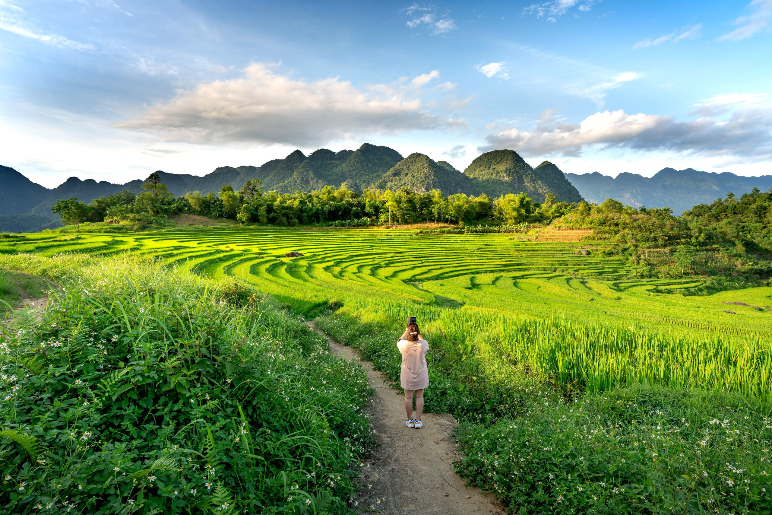 A visitor takes a photo of the terraces in Pu Luong
