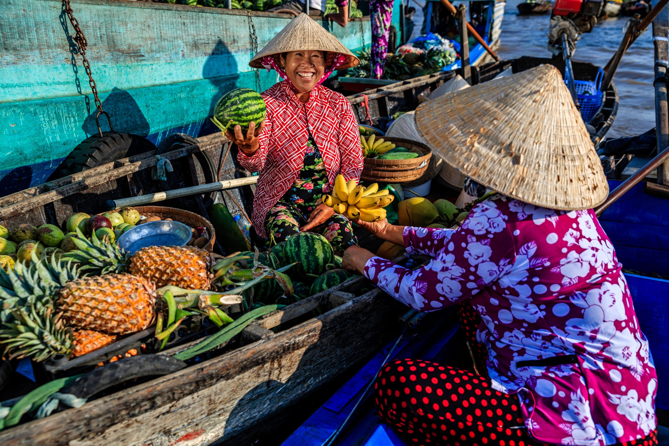 A fruit vendor at a floating market on the Mekong Delta