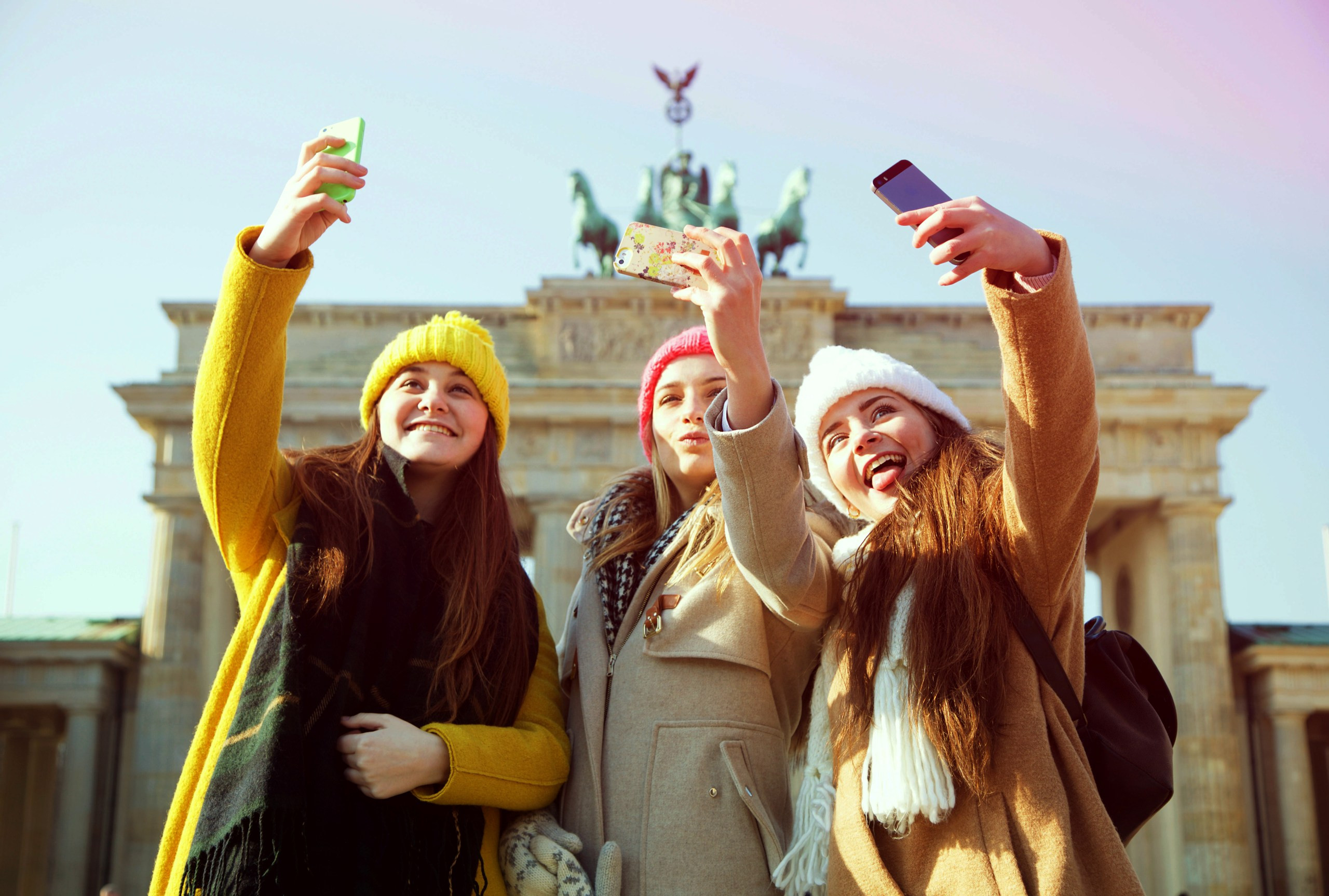 Visitors take selfies at the Brandenburg Gate in Berlin, a great place to go on holiday in December