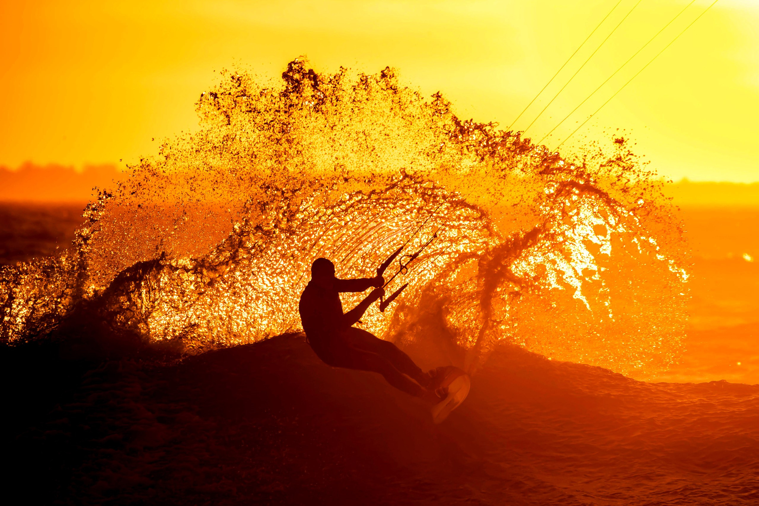 A kitesurfer amid the waves near Cape Town, South Africa, a great place to go on holiday in December
