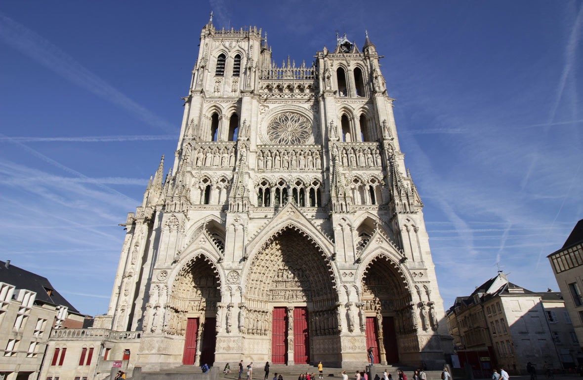 Large stone cathedral with red doors and decorative details