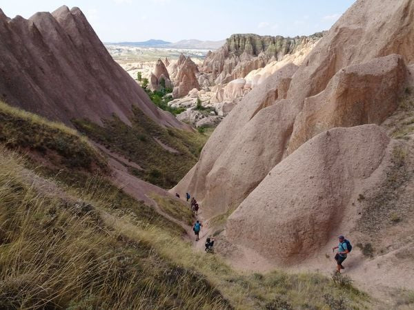 Hikers walk down a trail in Turkey