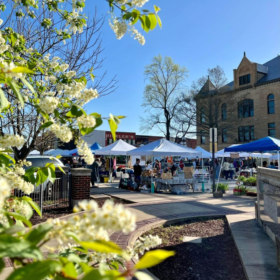 A photograph showcasing the booths and grounds of the farmers