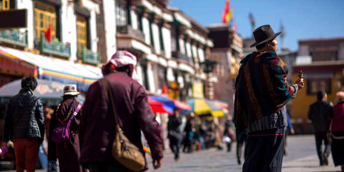 A guided tour group exploring the Barkhor Street in Lhasa, highlighting the cultural richness and local experience