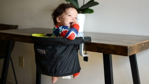 hook-on travel highchair securely attached to a table