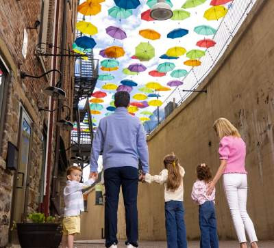 Visitors gather underneath umbrellas in downtown Scranton PA during a local event