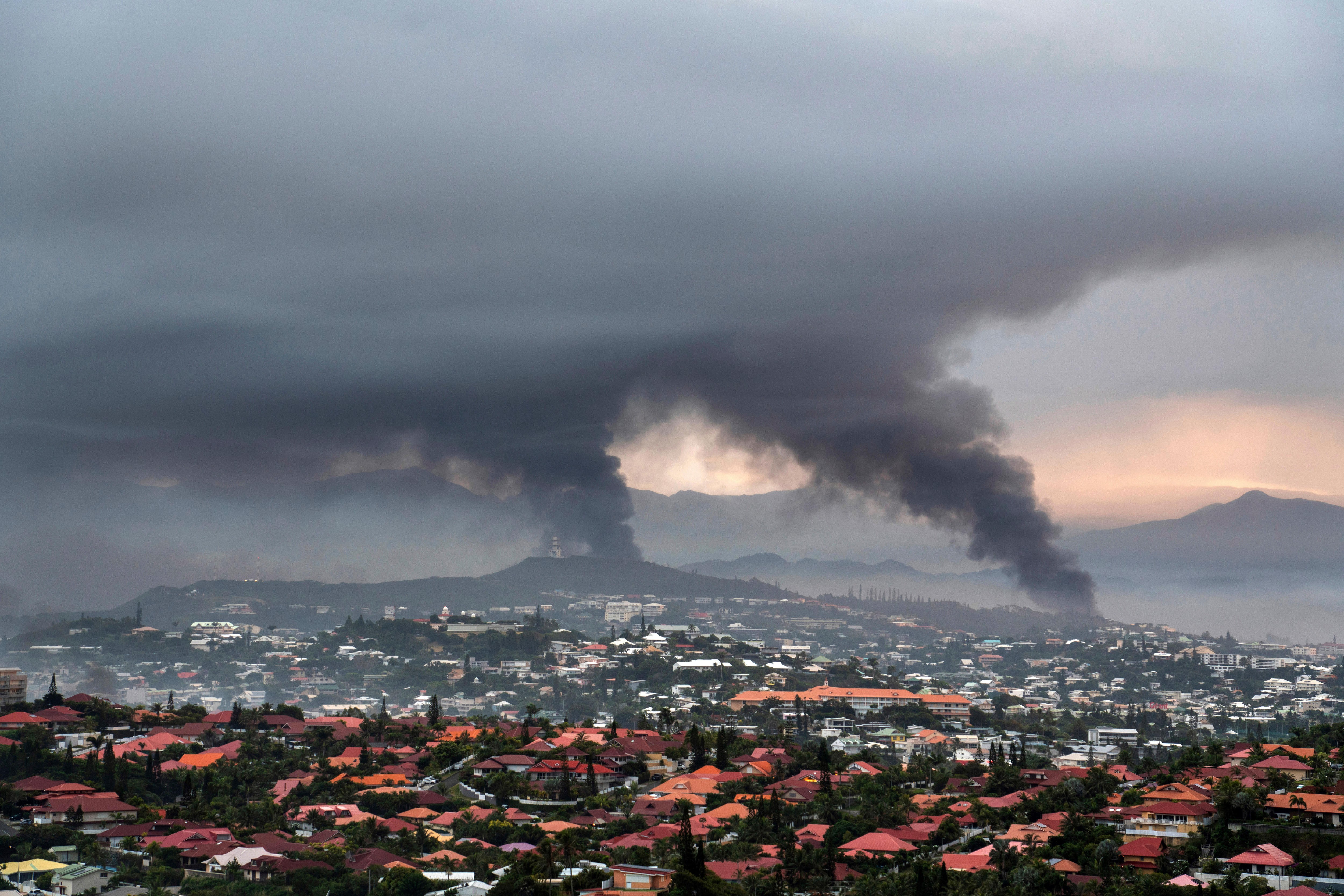Smoke rises over city of Noumea, in New Caledonia.
