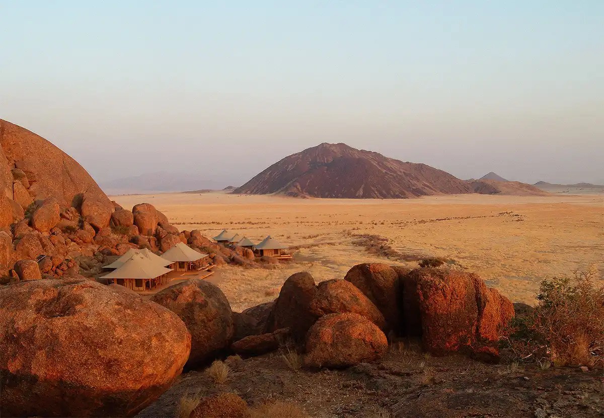 Namib-Naukluft Park Namibia tourism attraction: Wide open spaces with purply-blue mountains and desert landscapes.