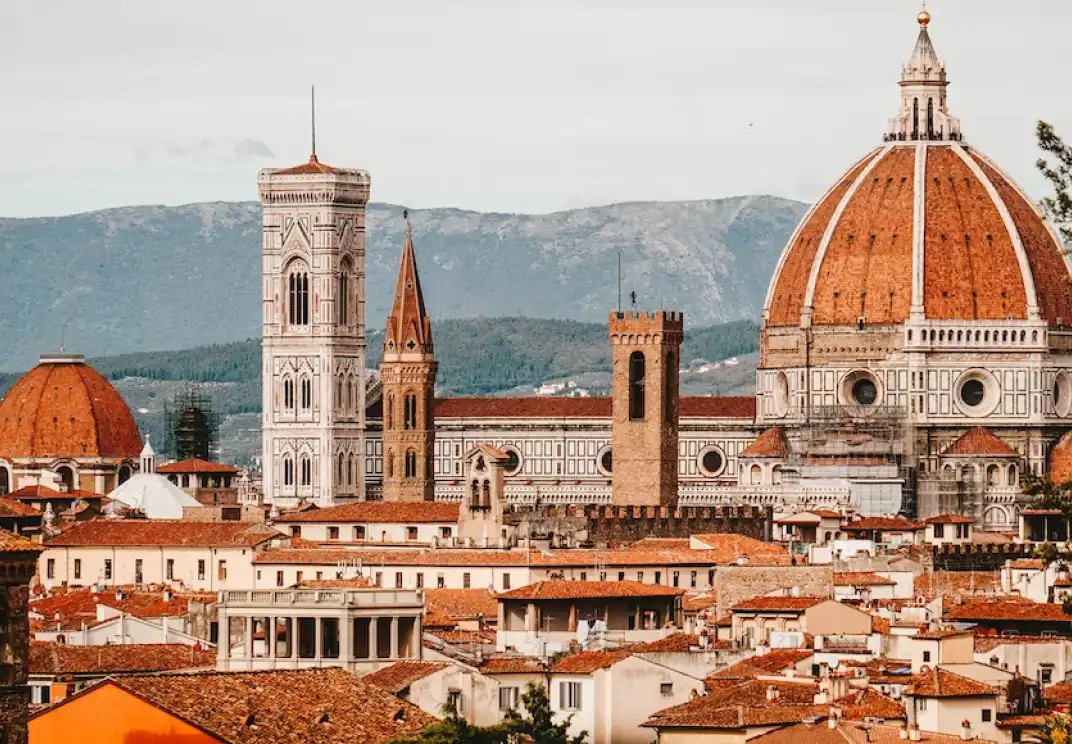 Florence Cathedral and cityscape with terracotta roofs and mountains