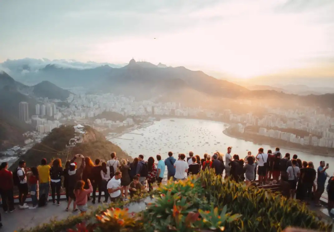 Tourists view sunrise over Rio de Janeiro