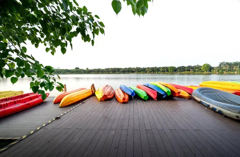 Colorful kayaks lined up on a wooden dock