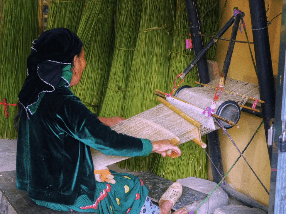 A local weaving traditional fabric on a loom in Tuyen Quang.