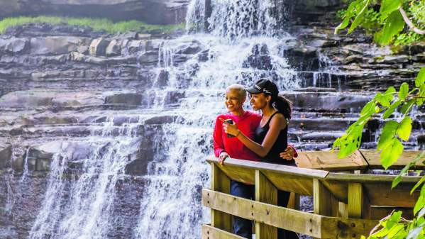 Two women standing on a balcony overlooking Brandywine Falls