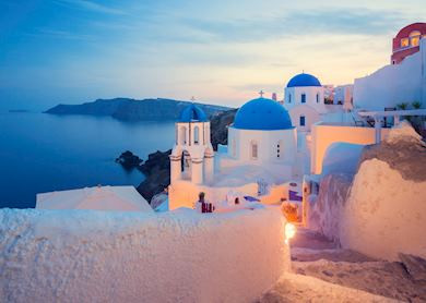 Evening views in Fira, Santorini, showcasing the island's stunning sunsets and white homes on cliffsides.