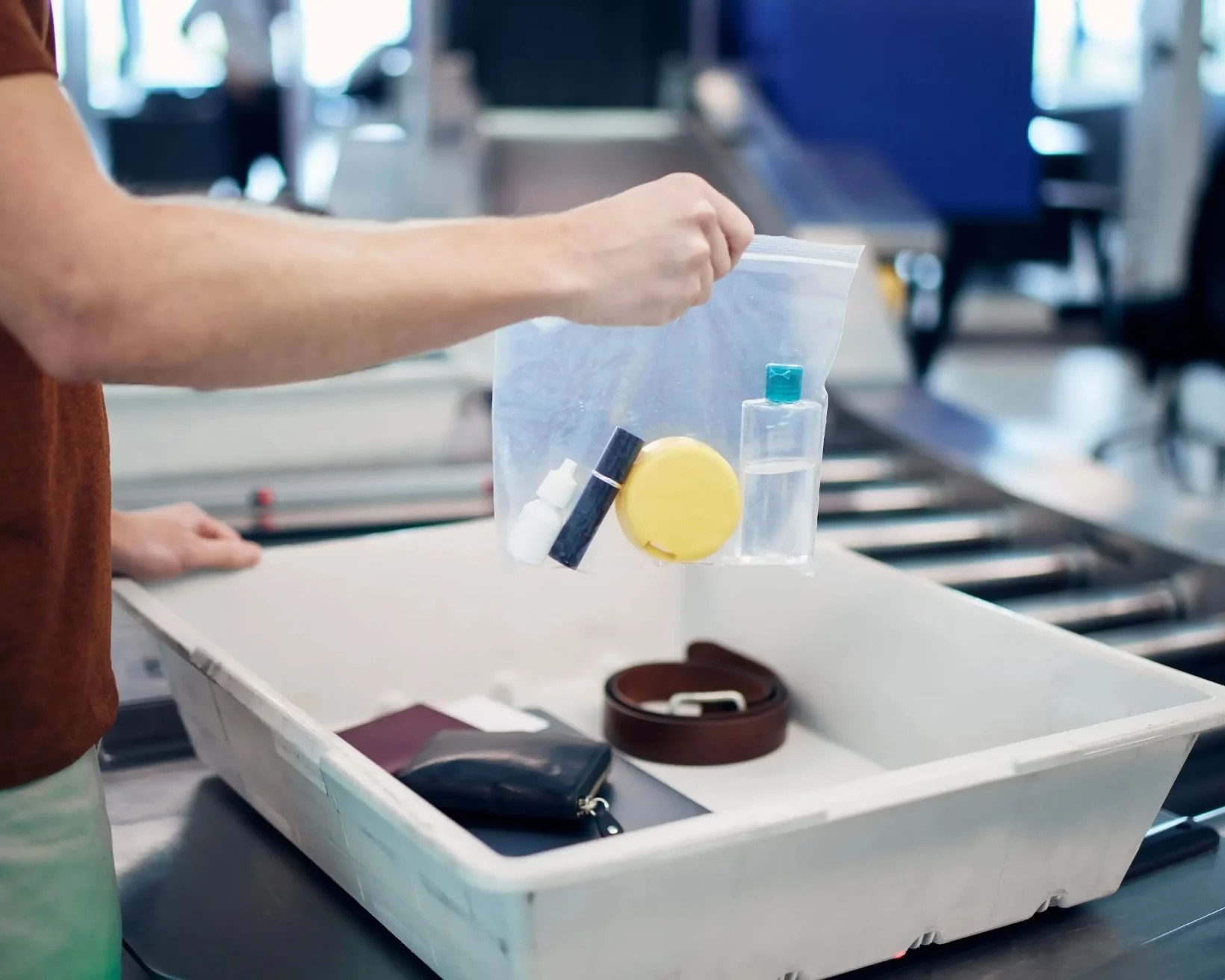 A man packing his liquids into a plastic bag at the airport security check point