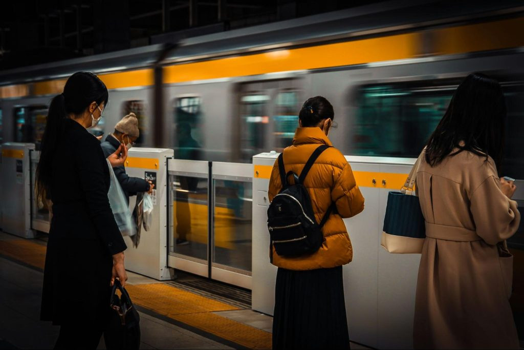 People waiting for the train in an orderly manner at a Japanese train station