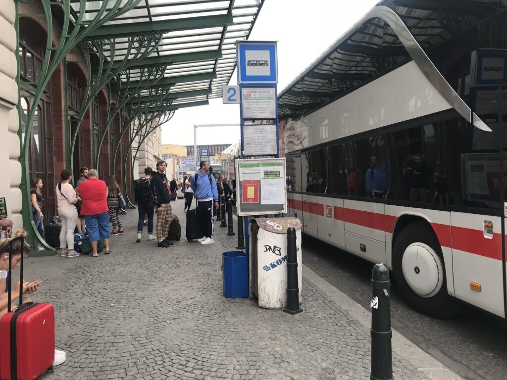Passengers boarding a local bus in a charming European town, highlighting the affordability and local feel of this transportation option.